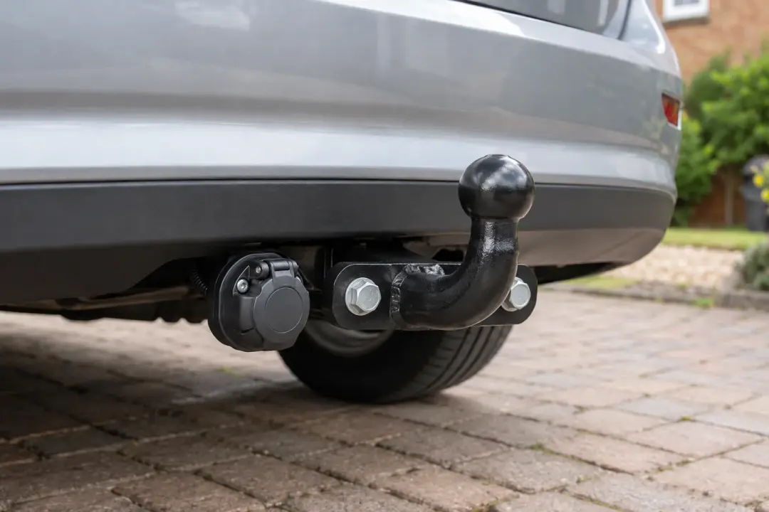Black fixed flange towbar mounted below a silver bumper